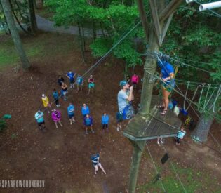 A Group Of People Flying A Kite