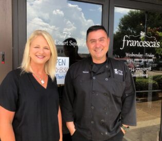 A Man And Woman Posing For A Photo