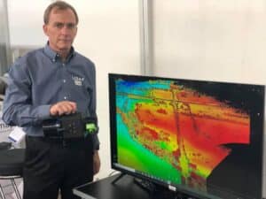 a man standing in front of a monitor